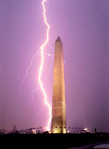 Photo of the Washington Monument with lightening in the background